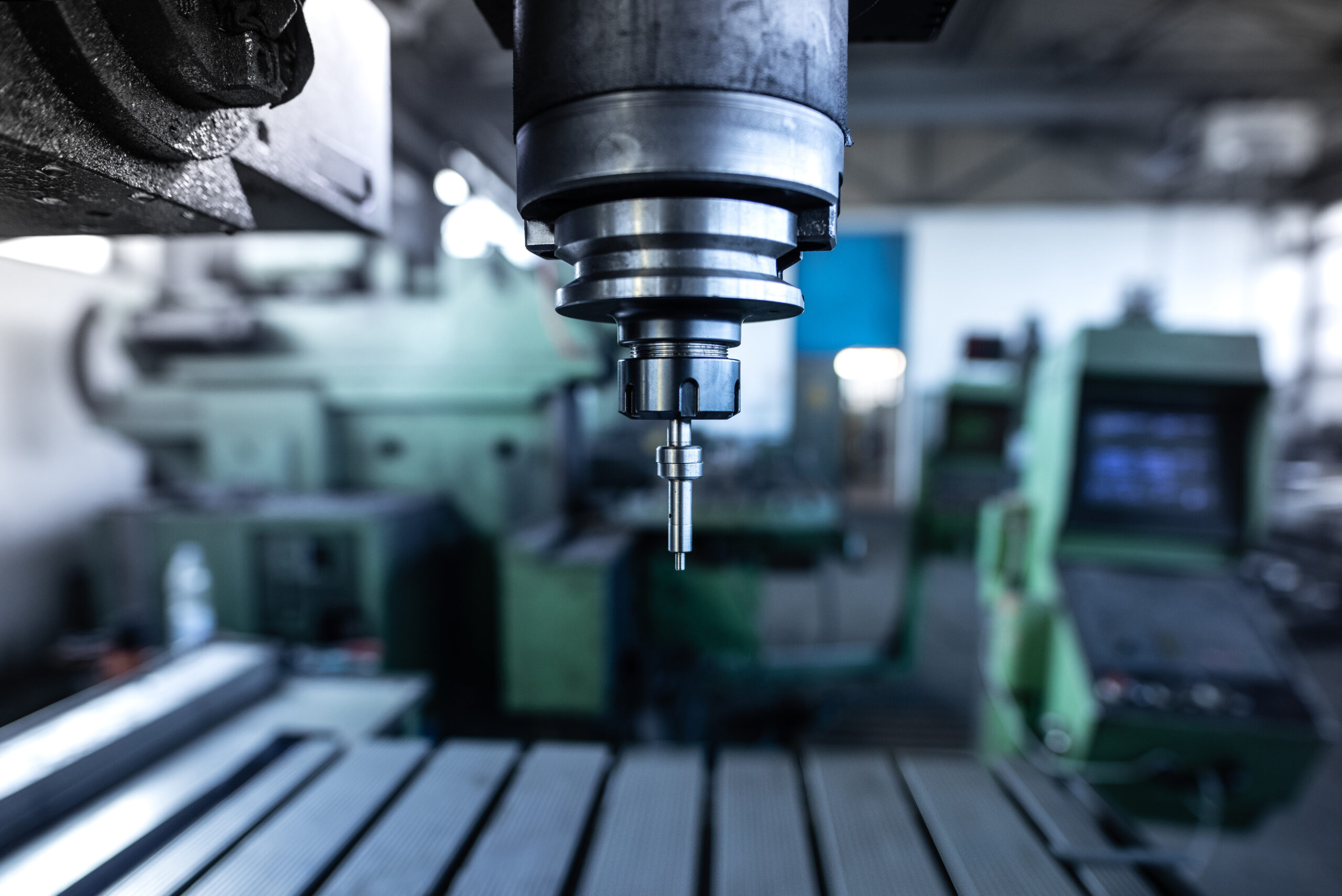 industrial metal drill machine in metalworking workshop.