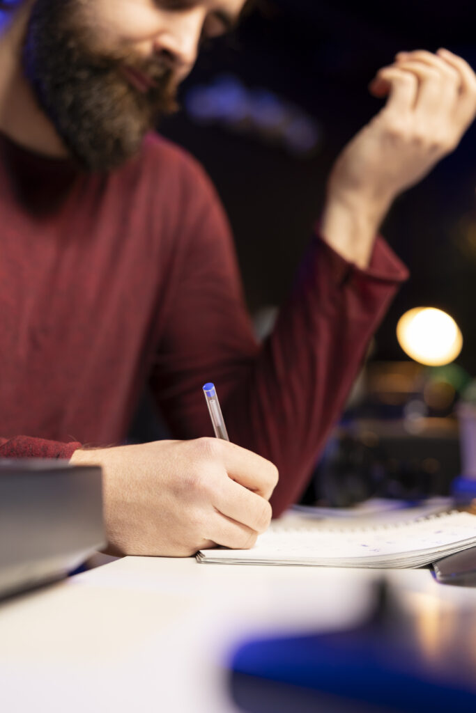 musician writes down lines and melodic elements to create new soundtracks